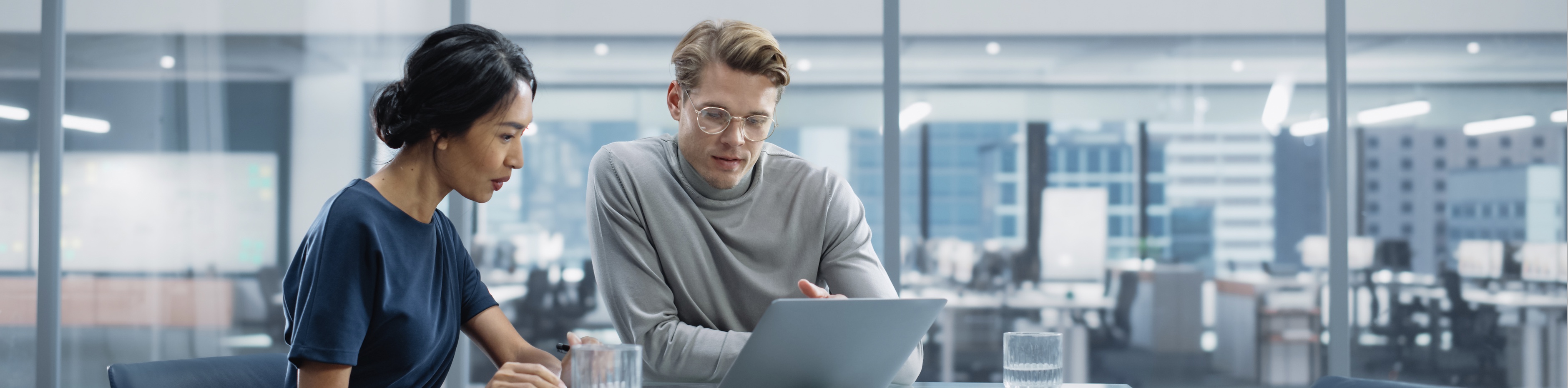 Woman and man at desk with laptop