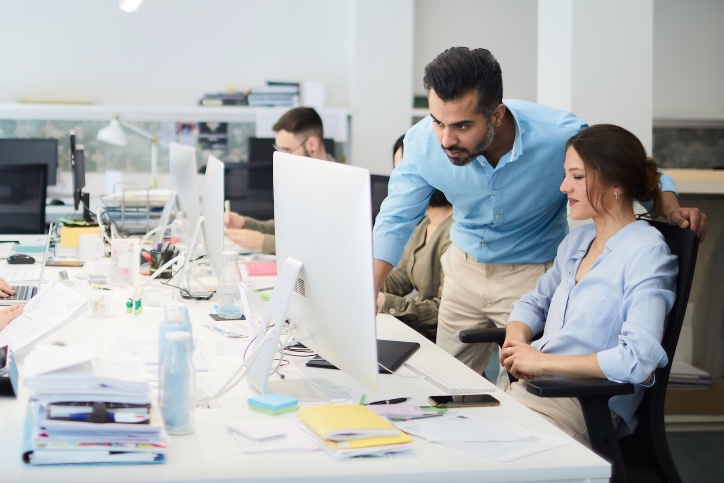 Man with woman looking at computer