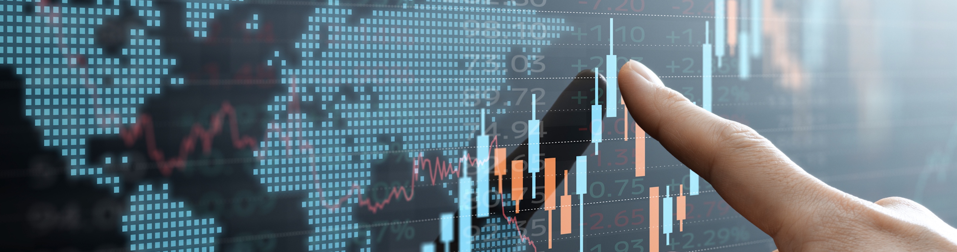 Hand pointing at a digital financial chart with candlestick graphs and global data map in the background, representing investment analysis and market trends.